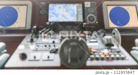 Navigational control panel and VHF radio. Working on the ship's navigational bridge. Blurred image. 111955647
