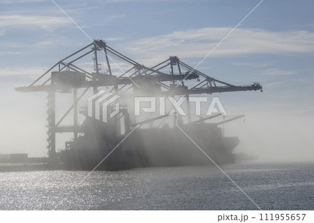 Container ship in port, strong fog. Foggy weather. Bad visibility. 111955657