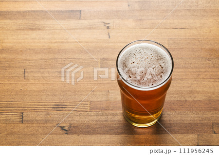 Craft beer in pint glass on a wooden table 111956245
