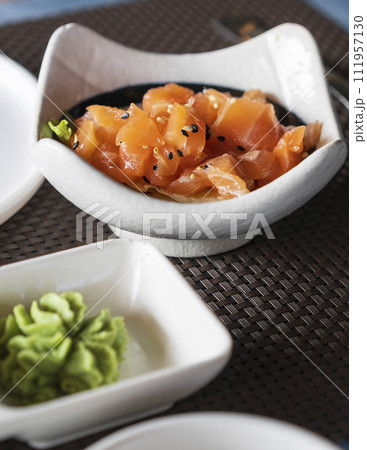 A bowl of delicious salmon tartare with sesame and herbs 111957130