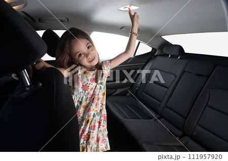 Kid on rear car passenger seat side Kid on rear car passenger seat side 111957920