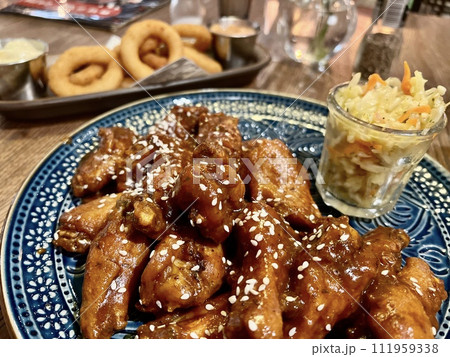 Teriyaki chicken wings under cherry souse with sesame seeds and pickled cabbage Teriyaki chicken wings under cherry souse with sesame seeds and pickled cabbage 111959338