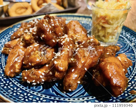 Teriyaki chicken wings under cherry souse with sesame seeds and pickled cabbage  111959340