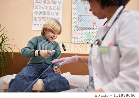 Portrait of smiling little boy having fun playing with tools in doctors office at pediatric clinic copy space Portrait of smiling little boy having fun playing with tools in doctors office at pediatric clinic copy space 111959660