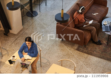 High angle view at people working in coffee shop or coworking area in office copy space 111959908