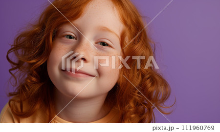 Red haired child portrait, girl in yellow t-shirt with redhead hair happy smiling on solid neutral violet background 111960769