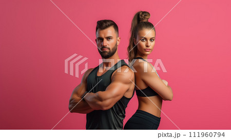 Girl and man together fitness trainers portrait, black sport cloth and dark hair in a pose with their backs to each other showing muscles, isolated on light red background 111960794