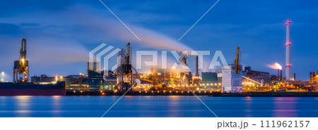 Oil refining. Heavy industry. View of production and factory. Panoramic view of the factory at night. Oil refining. Heavy industry. View of production and factory. Panoramic view of the factory at night. 111962157
