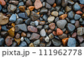 Colorful pebble texture for background, small stones in varying shades, colored beach stones 111962778