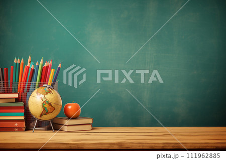 Educational tools on a desk against a chalkboard, back to schoo 111962885
