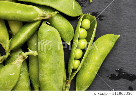 Fresh Green Peas on Slate Background Fresh Green Peas on Slate Background 111963350