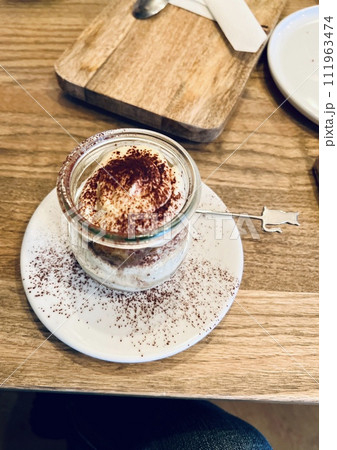 Tiramisu dessert in a glass jar on a wooden table 111963474