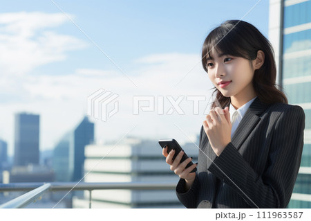 屋上でスマホを操作するビジネスウーマン 111963587