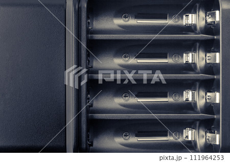 Battery compartment close-up. Battery charger. 111964253
