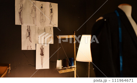 Empty sewing shop with tools and fabric, handmade and craft industry with instruments and industrial machines. Fashion atelier with clothes sketches and textile needlework equipment. 111964671