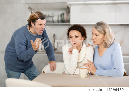 Man proves to woman that he is right, she is upset and her mother comforts her Man proves to woman that he is right, she is upset and her mother comforts her 111964704
