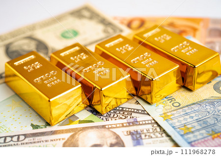 Gold bar on US dollar and Euro banknote, economy finance exchange trade investment. Gold bar on US dollar and Euro banknote, economy finance exchange trade investment. 111968278