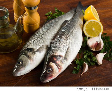 Raw sea bass on cutting board 111968336