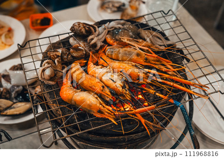Shrimp grilled in a charcoal grill at a street food 111968816