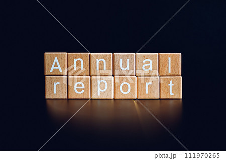 Wooden blocks form the text "Annual report" against a black background. Wooden blocks form the text "Annual report" against a black background. 111970265