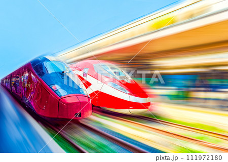 Modern hi-speed passenger train, in  movement (motion) on railways station. 111972180