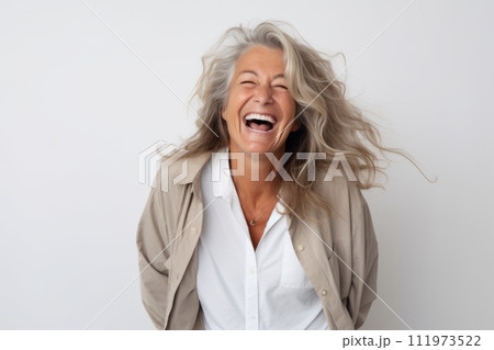 Portrait of a happy senior woman laughing isolated over white background 111973522