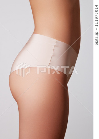 Young woman with beautiful buttocks. Rear view of 111975014