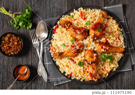 fried chicken drumsticks over rice pilaf, top view fried chicken drumsticks over rice pilaf, top view 111975190