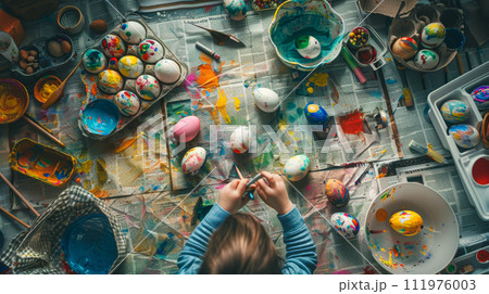 a child enthusiastically creates Easter egg masterpieces 111976003