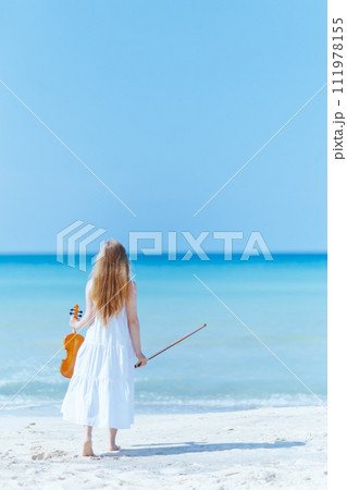 relaxed modern teen girl in light dress on seashore relaxed modern teen girl in light dress on seashore 111978155