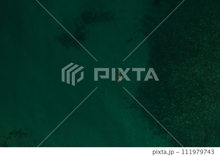 Aerial top nature view above green turquoise Thracian sea Greece Ellada. Beautiful woman bikini 111979743