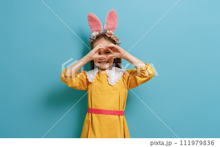 child wearing bunny ears on Easter day 111979836
