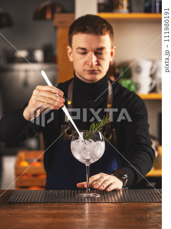 Expert barman is making cocktail Expert barman is making cocktail 111980191