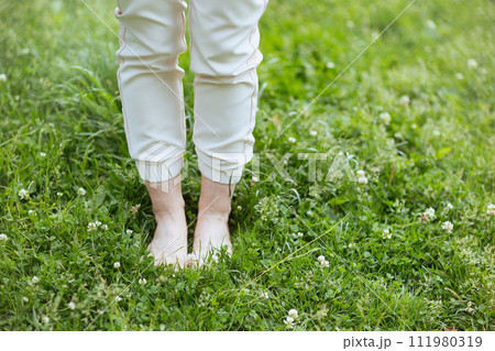 Closeup on woman in meadow outdoors Closeup on woman in meadow outdoors 111980319