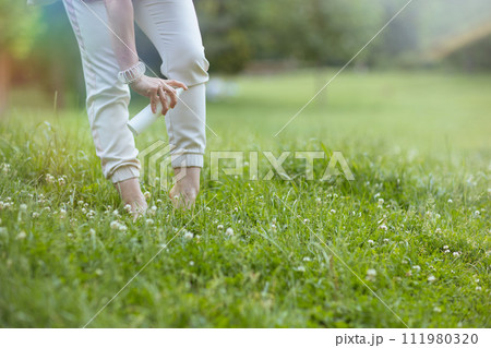 Closeup on modern woman in white shirt with repellent spray 111980320