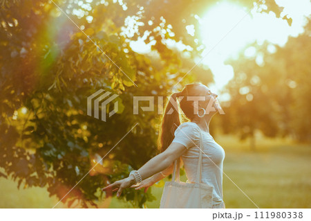 smiling elegant woman in white shirt rejoicing 111980338