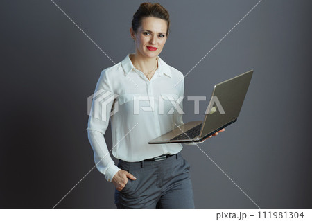 stylish business woman in white blouse isolated on grey 111981304