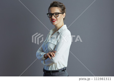 happy trendy 40 years old woman employee against gray happy trendy 40 years old woman employee against gray 111981311
