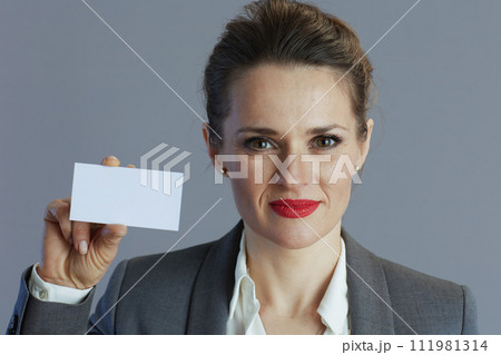 Stylish 40 years old woman employee isolated on grey Stylish 40 years old woman employee isolated on grey 111981314