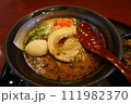 Ramen Japanese noodle dish served in a broth with sliced pork, green onion, boiled egg 111982370