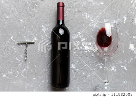 Flat lay composition with corkscrew, bottle of wine and elegant glass on colored table. Flat lay, top view wth copy space 111982605