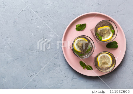 Healthy breakfast or morning with chia seeds lemon and mint on table background, vegetarian food, diet and health concept. Chia pudding with lemon and mint 111982606