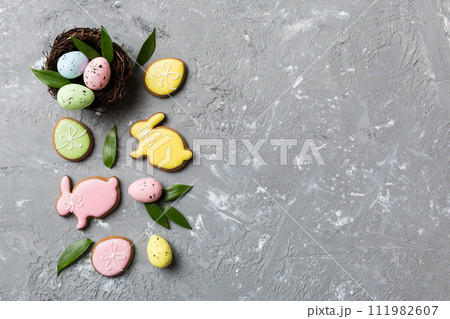 Colorful easter eggs in nest on table background with copy space top view 111982607