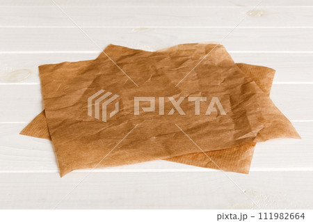 top view with baking parchment empty on table background. Folded cloth for mockup with copy space, Flat lay. Minimal style 111982664