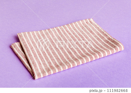 top view with red empty kitchen napkin isolated on table background. Folded cloth for mockup with copy space, Flat lay. Minimal style 111982668