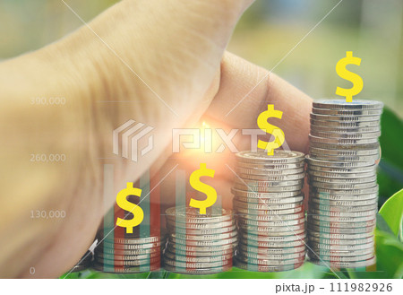 coin stack with hand stacking gold coins coin stack with hand stacking gold coins 111982926