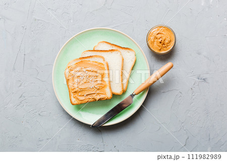 Peanut butter sandwiches or toasts on light table background.Breakfast. Vegetarian food. American cuisine top view vith copy space 111982989