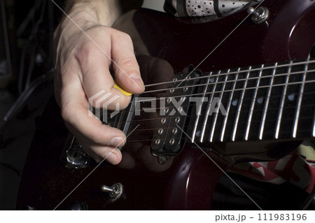 Hand plays the guitar. Iterate over the strings. 111983196