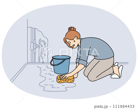 Worried woman clean water from burst pipe 111984433
