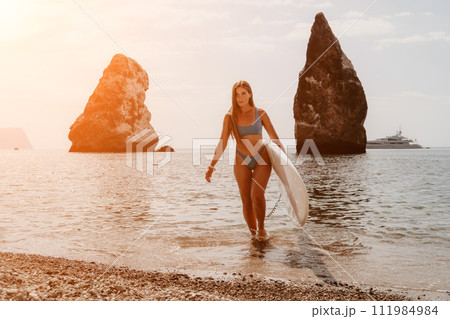 Woman sea sup. Close up portrait of happy young caucasian woman with long hair looking at camera and smiling. Cute woman portrait in bikini posing on sup board in the sea Woman sea sup. Close up portrait of happy young caucasian woman with long hair looking at camera and smiling. Cute woman portrait in bikini posing on sup board in the sea 111984984